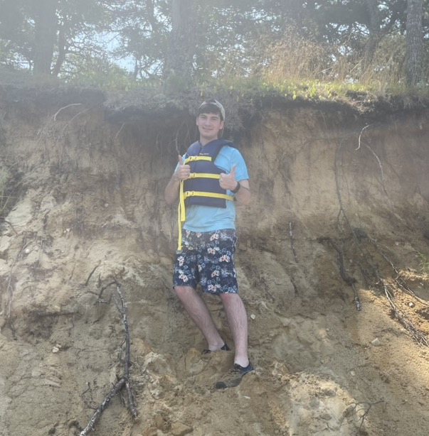 Aaron in Cape Cod, boating, giving a thumbs up