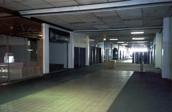 An empty indoor commercial corridor that feels uncanny and liminal.